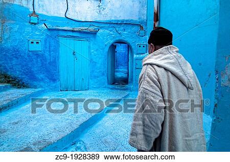 Man walking on the blue streets of the medina, Chefchaouen, Rif region, Morocco View Large Photo Image Stock Photo - Man walking on the blue streets of the medina, Chefchaouen, Rif region, Morocco. Fotosearch