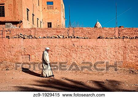 Man walking on the streets of Tinerhir, Dades Valley, Morocco View Large Photo Image Stock Photography - Man walking on the streets of Tinerhir, Dades Valley, Morocco. Fotosearch