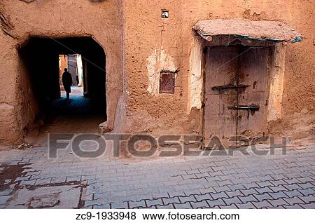Man walking through a passage in the mellah (jewish neighborhood), Ouarzazate, Morocco View Large Photo Image Stock Photo - Man walking through a passage in the mellah (jewish neighborhood), Ouarzazate, Morocco. Fotosearch