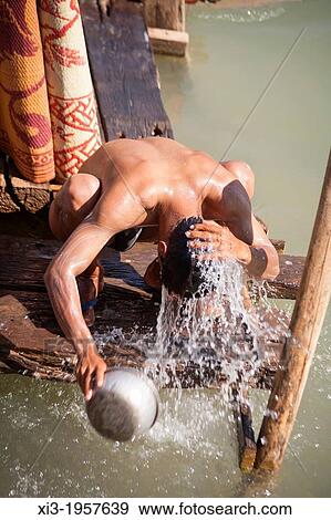 Man washing himself beside Inle Lake, Indein Village, near Taunggyi, Shan State, Myanmar, (Burma). View Large Photo Image Stock Photo - Man washing himself beside Inle Lake, Indein Village, near Taunggyi, Shan State, Myanmar, (Burma).. Fotosearch