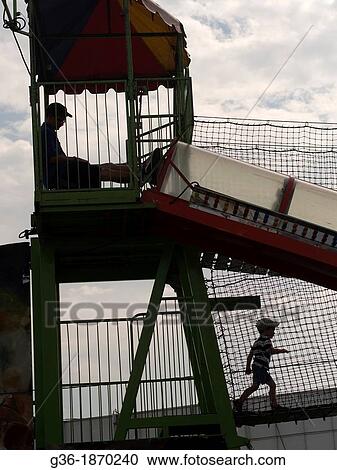 Man watchting children play at the Sussex County Fair in Augusta, New Jersey View Large Photo Image Stock Image - Man watchting children play at the Sussex County Fair in Augusta, New Jersey. Fotosearch