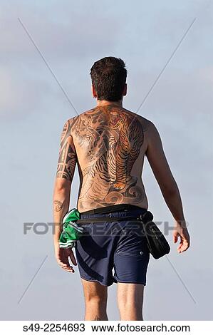 Man wearing a big and colorful tattoo on his back. View Large Photo Image Stock Image - Man wearing a big and colorful tattoo on his back.. Fotosearch