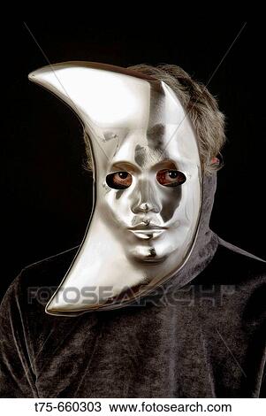 Stock Image - Man wearing a carnival mask.. Fotosearch