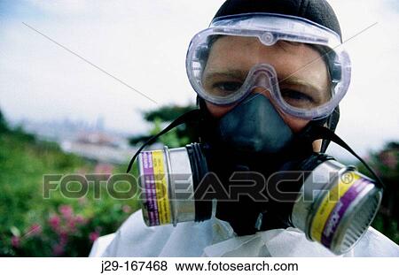 Man wearing a respiratory mask for organic vapors like asbestos, dust and particulate aerosols View Large Photo Image Stock Photo - Man wearing a respiratory mask for organic vapors like asbestos, dust and particulate aerosols. Fotosearch
