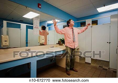 Man, wearing glasses and a tie, standing in an office building bathroom. View Large Photo Image Stock Image - Man, wearing glasses and a tie, standing in an office building bathroom.. Fotosearch