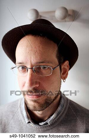 Man wearing glasses and hat View Large Photo Image Stock Image - Man wearing glasses and hat. Fotosearch