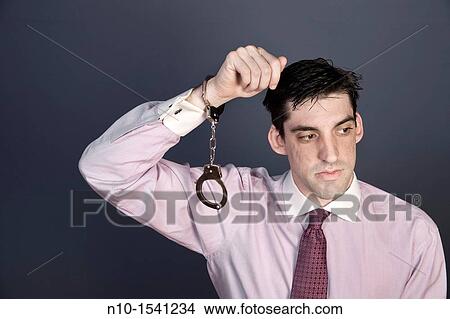 Man wearing handcuffs on one wrist View Large Photo Image Picture - Man wearing handcuffs on one wrist. Fotosearch