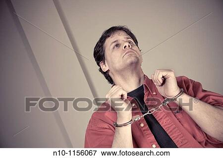 Man wearing handcuffs View Large Photo Image Stock Photo - Man wearing handcuffs. Fotosearch
