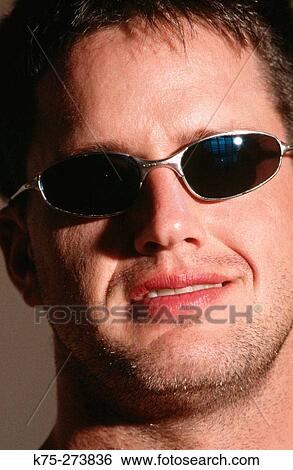 Man wearing sunglasses View Large Photo Image Stock Photograph - Man wearing sunglasses. Fotosearch