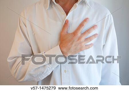 Man wearing white shirt, with hand on heart. View Large Photo Image Stock Photo - Man wearing white shirt, with hand on heart.. Fotosearch