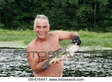 Stock Photo - Man who just caught a good bass. Fotosearch