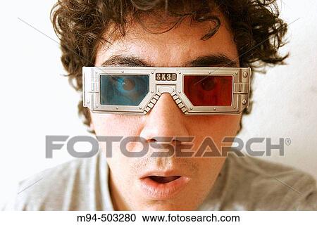 Stock Image - Man with 3D glasses looking to something surprised.. Fotosearch