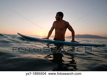 Man with a surf board in the sea. Tarifa, Costa de la Luz, Cadiz, Andalusia, Spain, Europe. View Large Photo Image Picture - Man with a surf board in the sea. Tarifa, Costa de la Luz, Cadiz, Andalusia, Spain, Europe.. Fotosearch