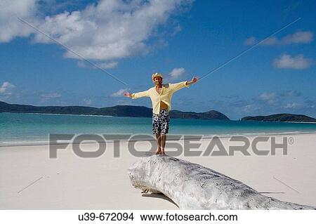 Man with arms outstretched. Whitehaven Beach, Australia. View Large Photo Image Picture - Man with arms outstretched. Whitehaven Beach, Australia.. Fotosearch