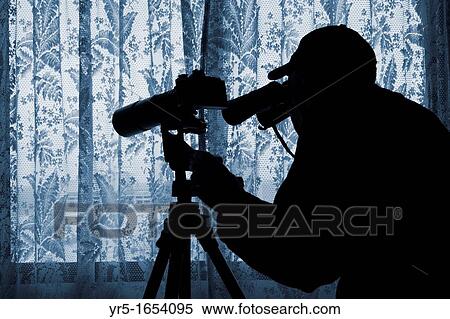 Man with binoculars and camera with long lens looking out of window through net curtains Image could be used to convey a number of themes: spying, nosey neighbour, press intrusion, paparazzi, stalker, big brother, police state Photo posed by model View Large Photo Image Stock Photography - Man with binoculars and camera with long lens looking out of window through net curtains Image could be used to convey a number of themes: spying, nosey neighbour, press intrusion, paparazzi, stalker, big brother, police state Photo posed by model. Fotosearch