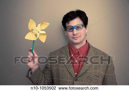 Man with broken glasses holding a pinwheel View Large Photo Image Stock Image - Man with broken glasses holding a pinwheel. Fotosearch