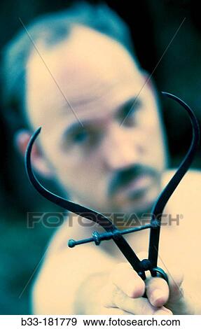Stock Photo - Man with callipers. Fotosearch