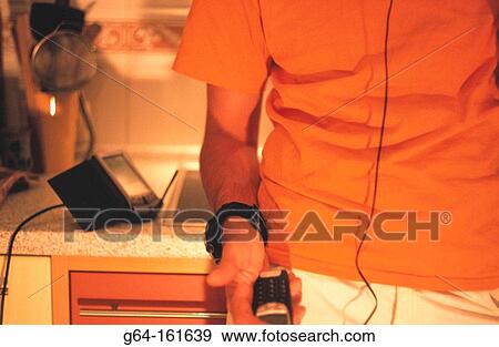 Stock Photo - Man with cell phone and palm pilot. Fotosearch