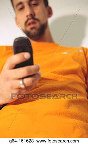 Man with cell phone View Large Photo Image Stock Photo - Man with cell phone. Fotosearch