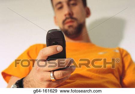 Man with cell phone View Large Photo Image Stock Photo - Man with cell phone. Fotosearch