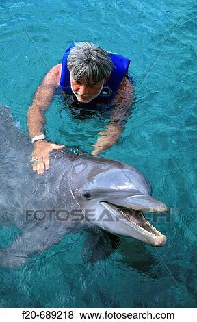 Stock Photo - Man with dolphin, Xcaret. Quintana Roo, Mexico. Fotosearch