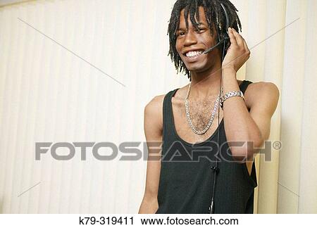 Man with dreadlocks listening to music. View Large Photo Image Stock Image - Man with dreadlocks listening to music.. Fotosearch