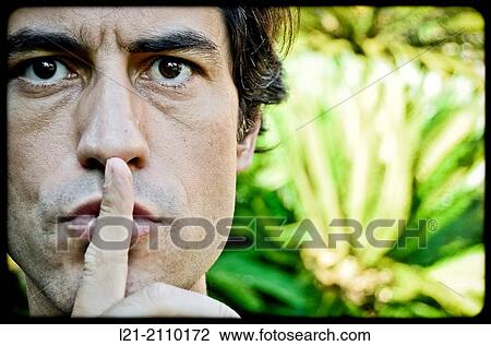 Stock Image - Man with Finger on Lips. Fotosearch