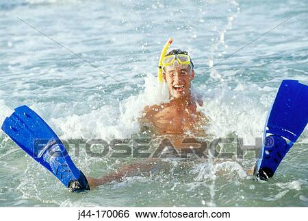 Man with flippers mask and snorkel in the water at the beach View Large Photo Image Stock Photograph - Man with flippers mask and snorkel in the water at the beach. Fotosearch