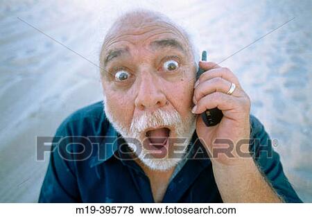 man with funny face/big eyes on cell phone View Large Photo Image Stock Photo - man with funny face/big eyes on cell phone. Fotosearch