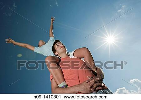 Stock Image - Man with girl on shoulders. Fotosearch