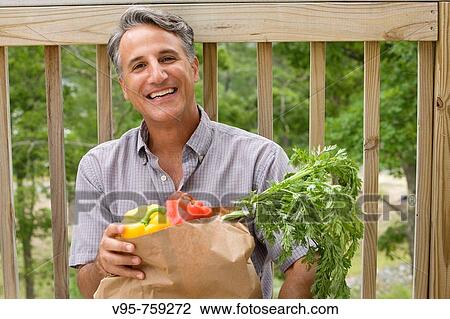 Man with grocery bag View Large Photo Image Stock Image - Man with grocery bag. Fotosearch