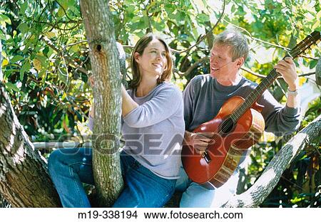 man with guitar serranaiding a woman View Large Photo Image Picture - man with guitar serranaiding a woman. Fotosearch