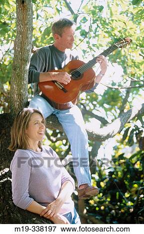 man with guitar serranaiding a woman View Large Photo Image Stock Photo - man with guitar serranaiding a woman. Fotosearch