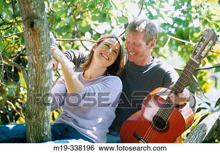 man with guitar serranaiding a woman View Large Photo Image Stock Photograph - man with guitar serranaiding a woman. Fotosearch