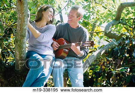 man with guitar serranaiding a woman View Large Photo Image Stock Photography - man with guitar serranaiding a woman. Fotosearch