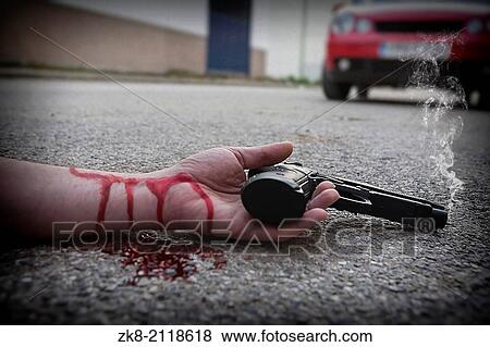 Man with gun in hand bloodstained lies dead in the asphalt murder victim. View Large Photo Image Stock Photo - Man with gun in hand bloodstained lies dead in the asphalt murder victim.. Fotosearch