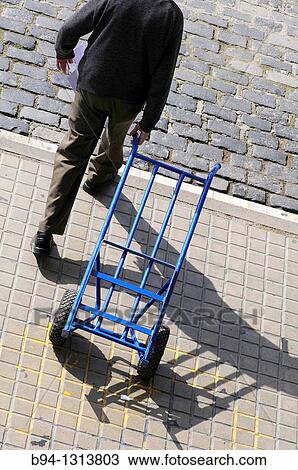 Stock Image - Man with hand truck. Fotosearch