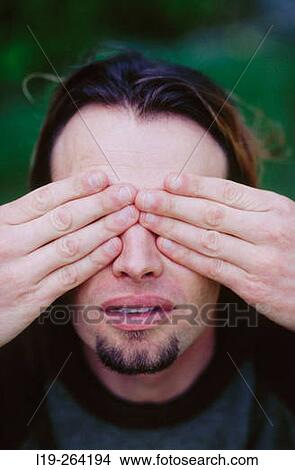 Picture - Man with hands over his eyes. Fotosearch
