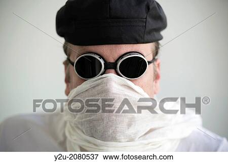 Man with hat and sunglasses and a scarf cover his face. View Large Photo Image Stock Photo - Man with hat and sunglasses and a scarf cover his face.. Fotosearch
