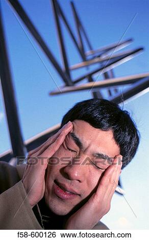 Stock Photograph - Man with headache.. Fotosearch