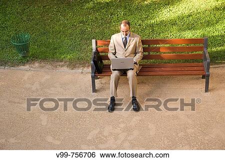 Man with laptop computer in park View Large Photo Image Stock Photograph - Man with laptop computer in park. Fotosearch