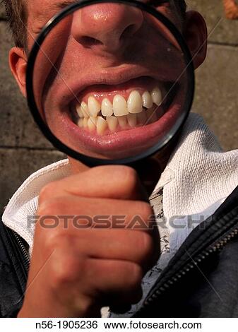 Stock Photograph - Man with magnifying glass. Fotosearch