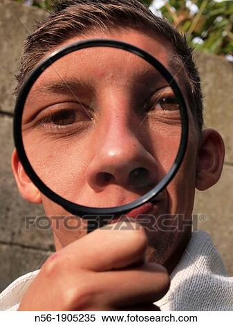 Stock Photography - Man with magnifying glass. Fotosearch
