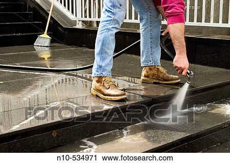 Man, with only his legs visible, using a hose to wash the ledge in front of an office building View Large Photo Image Stock Image - Man, with only his legs visible, using a hose to wash the ledge in front of an office building. Fotosearch