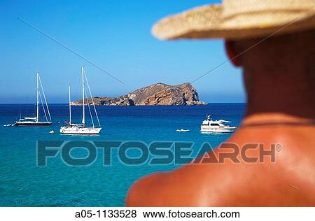 Man with straw hat. Comte Beach. Ibiza. Balearic Islands. Spain. View Large Photo Image Stock Photo - Man with straw hat. Comte Beach. Ibiza. Balearic Islands. Spain.. Fotosearch