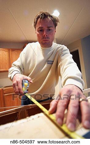 Man with tape measure View Large Photo Image Stock Photo - Man with tape measure. Fotosearch