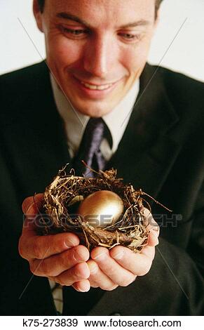 Man with the golden egg View Large Photo Image Stock Photo - Man with the golden egg. Fotosearch