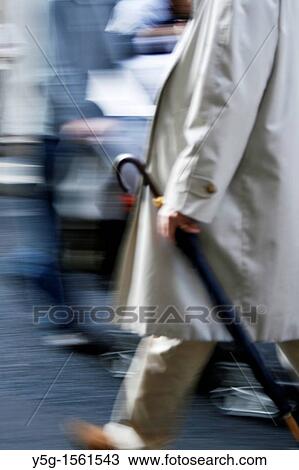 man with umbrella and holding newspaper in town View Large Photo Image Stock Image - man with umbrella and holding newspaper in town. Fotosearch