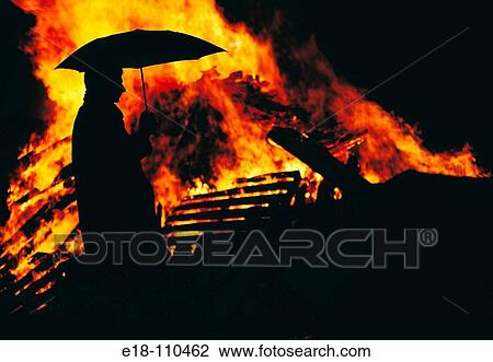 Man with umbrella in front of fire View Large Photo Image Stock Image - Man with umbrella in front of fire. Fotosearch
