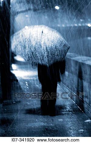 Man with umbrella in the rain on the Ile Saint Louis. Paris. France View Large Photo Image Stock Image - Man with umbrella in the rain on the Ile Saint Louis. Paris. France. Fotosearch